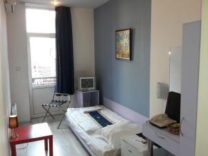 a small room with a bed and a window at Scotty's Boutique Hotel in Sofia