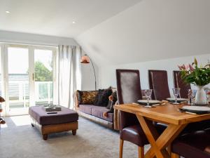 a living room with a table and a couch at Queens View Lodge in Inchmarlo