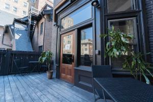 a patio with a table and a glass door at The Dubbel Dutch in Milwaukee