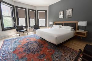 a bedroom with a large bed and a rug at The Dubbel Dutch in Milwaukee
