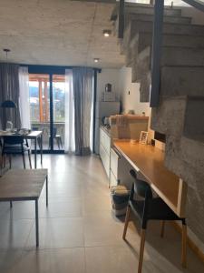 a kitchen and dining room with a table and chairs at ENTREVERDES Departamentos in El Bolsón