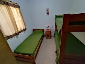a room with two bunk beds and a table at HUGO 1 in Colón