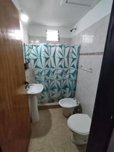 a bathroom with a toilet and a sink at HUGO 1 in Colón