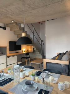 a dining room with a table and a living room at ENTREVERDES Departamentos in El Bolsón