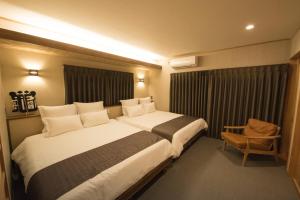 a hotel room with two beds and a chair at Izumo - House - Vacation STAY 13870v in Izumo