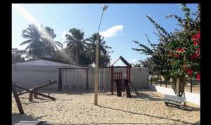a park with a playground with a swing set at Apartamento Mar de São josé in São José da Coroa Grande