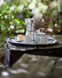 a tray with cups and a tea set on a table at Corte Boero Bed&Breakfast in Capoterra