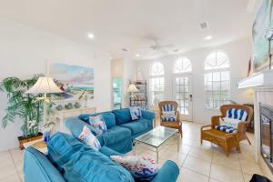 a living room with a blue couch and chairs at Southern Belle in St. George Island