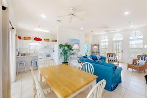 a living room with a blue couch and a table at Southern Belle in St. George Island
