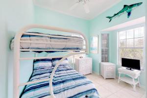 a bedroom with a bunk bed and a computer monitor at Southern Belle in St. George Island