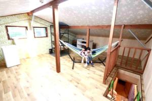 two children sitting in a hammock in a room at Atorie Bekkan - Vacation STAY 13448 in Shiozawa