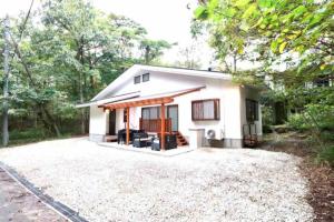 a small white house in the middle of a yard at Atorie Bekkan - Vacation STAY 13448 in Shiozawa