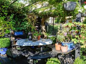 a garden with a table with potted plants on it at Church Cottage in Rigg
