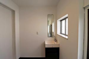 a bathroom with a sink and a mirror at WADACHI - Vacation STAY 13460 in Osaka