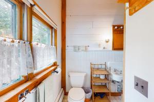 a bathroom with a toilet and a sink and a window at Lakefront Retreat in Naples +40 photos
