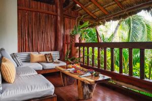 a living room with a couch and a table at Kanan Tulum - Adults Only in Tulum