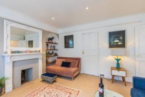 a living room with a couch and a fireplace at Seafront Apartment Private Garden & Free Parking in Littlehampton