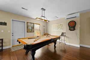 a pool table in the middle of a room at Crestview Estate 5 acres-heated pool-5min to strip in Pigeon Forge
