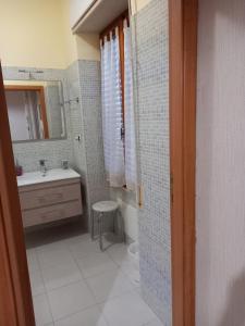 ein Bad mit einem Waschbecken und einem Spiegel in der Unterkunft Affittacamere Su Padru in Ittiri