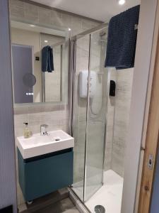 a bathroom with a sink and a shower at Southwell Home Stay in Southwell