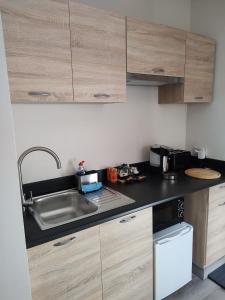 a kitchen with a sink and a counter top at Southwell Home Stay in Southwell