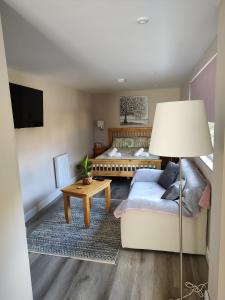 a living room with a bed and a couch at Southwell Home Stay in Southwell