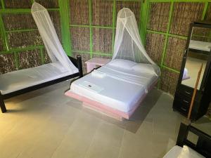 Postel nebo postele na pokoji v ubytování Eco Hotel Las Palmeras