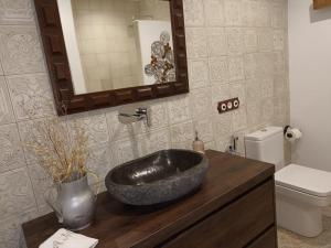a bathroom with a black sink on a wooden counter at Alto el Monte 2 - AR1414 in Bocines +18 photos