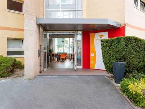 an entrance to a building with an open door at Hôtel F1 Reims Tinqueux in Reims