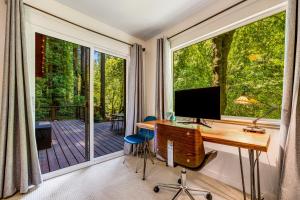 a home office with a desk and a large window at Caz Cabin 6 in Cazadero