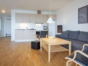 a living room with a couch and a table and a kitchen at 6 person holiday home in Allinge in Allinge
