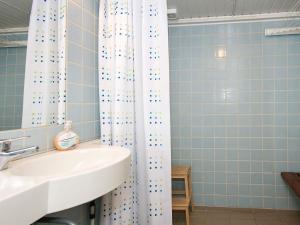 a bathroom with a sink and a shower curtain at 6 person holiday home in Aabenraa in Aabenraa