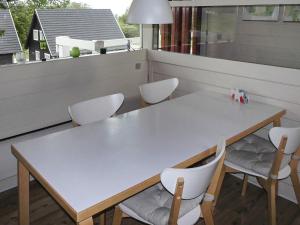 a white table and chairs on a balcony at 6 person holiday home in Aabenraa in Aabenraa