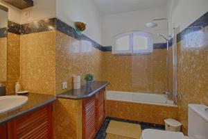 a bathroom with a sink and a shower and a toilet at Apartamento Olhos D'Água VistaBella in Olhos de Água +14 photos