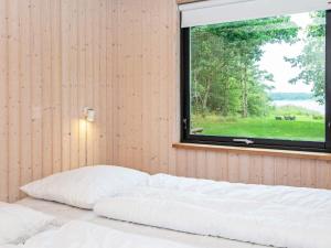 a bedroom with a bed and a window with a view at Holiday home Skanderborg V in Skanderborg