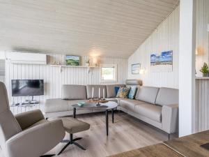 a living room with a couch and a table at Holiday home Vejers Strand XVIII in Vejers Strand