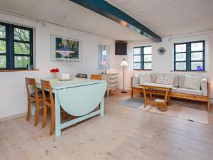 a living room with a table and a bath tub at 5 person holiday home in Bog By in Bogø By