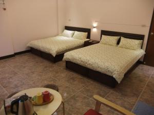 Postel nebo postele na pokoji v ubytování Jiufen Hui Ming Homestay