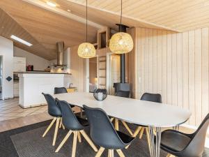 a dining room with a white table and chairs at 8 person holiday home in Fjerritslev in Fjerritslev