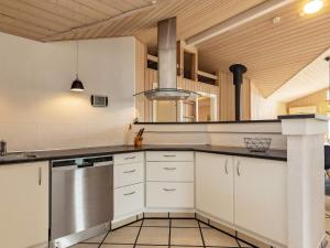 a kitchen with white cabinets and a stainless steel appliance at 8 person holiday home in Fjerritslev in Fjerritslev