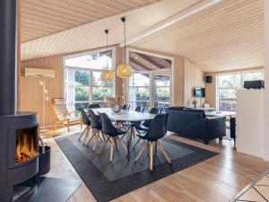 a living room with a table and a fireplace at 8 person holiday home in Fjerritslev in Fjerritslev