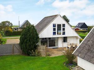 a white house with a fence and a yard at Holiday home Otterup XXII in Otterup