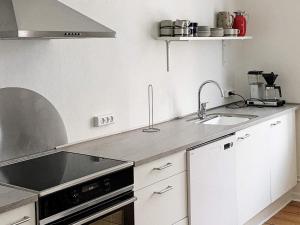 a kitchen with a sink and a stove top oven at 4 person holiday home in Nakskov in Nakskov
