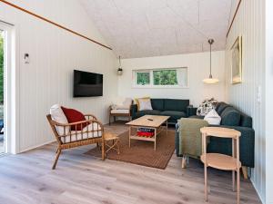 a living room with a couch and a table at Holiday home Ansager XXXVII in Ansager