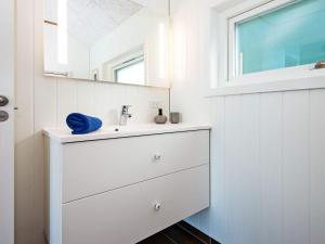 a white bathroom with a sink and a mirror at 12 person holiday home in Ansager-By Traum in Ansager +30 photos