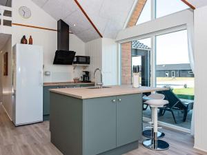 a kitchen with a refrigerator and a counter top at 12 person holiday home in Ansager-By Traum in Ansager