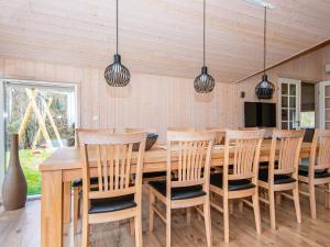 a dining room with a wooden table and chairs at 12 person holiday home in Ebeltoft in Ebeltoft