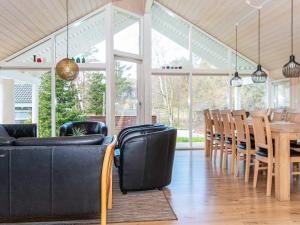 a dining room with a table and chairs at 12 person holiday home in Ebeltoft in Ebeltoft