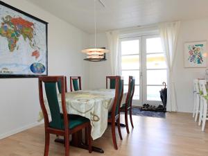 a dining room with a table and chairs at 6 person holiday home in R dby in Rødby