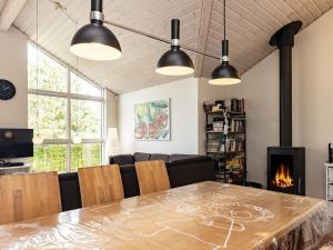 a dining room with a table and a fireplace at 8 person holiday home in Skals in Hjarbæk